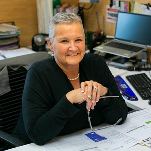 Woman at desk smiling at camera